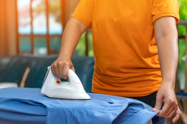 Woman Ware Orange Shirt Ironing Blue Shirt Iron Board Living — Stock Photo, Image