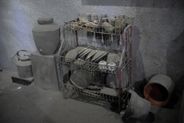 Yogyakarta, Indonesia, July 28, 2019. Artifacts of household appliances such as glass, plates, in a house of Merapi eruption victims affected by volcanic ash rain at the Mount Merapi Museum