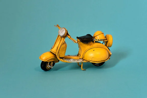 Old toy vespa motorbike on different backgrounds