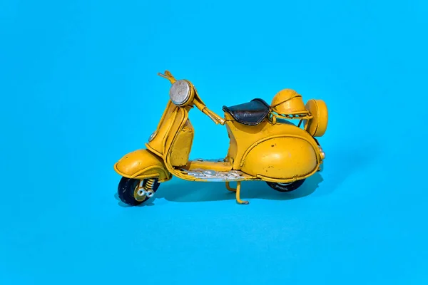 Old toy vespa motorbike on different backgrounds