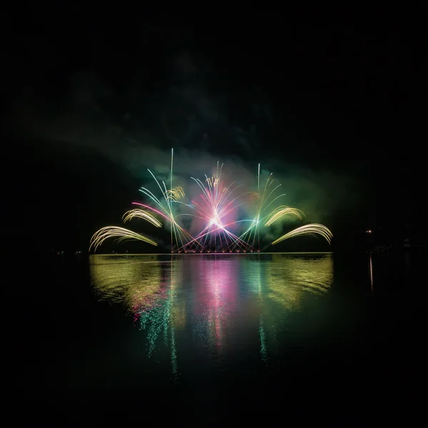 Fogos de artifício coloridos com reflexão no lago . — Fotografia de Stock