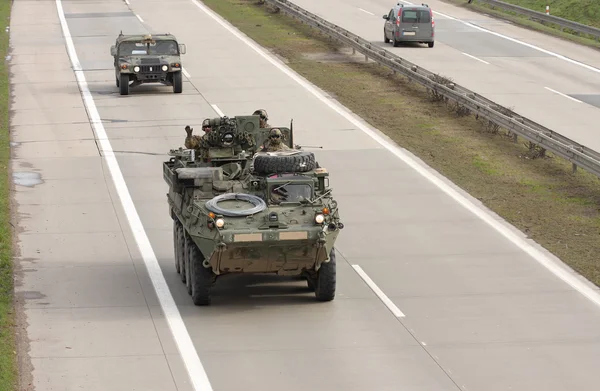 Stryker,wheeled armored vehicle drives on highway . — Stock Photo, Image