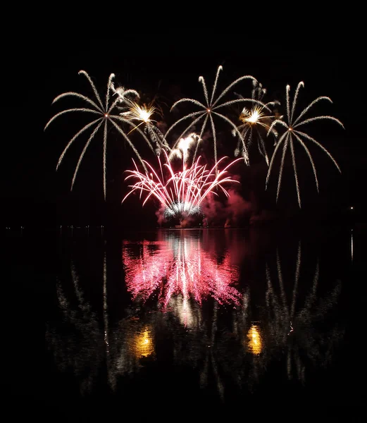 Farbenfrohes Feuerwerk mit Spiegelung am See. — Stockfoto