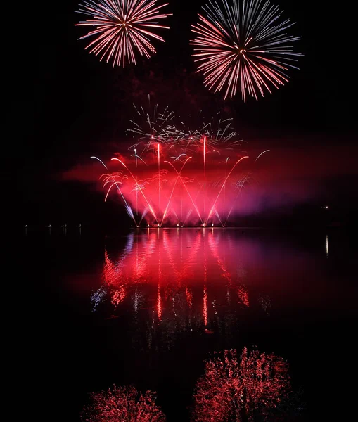 Farbenfrohes Feuerwerk mit Spiegelung am See. — Stockfoto