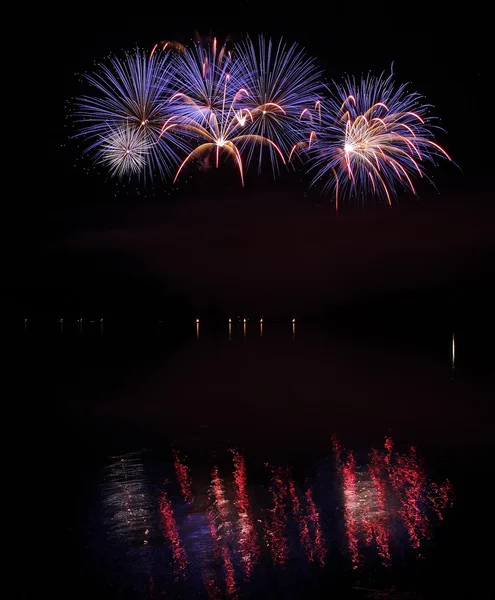 Colorful fireworks with reflection on lake. — Stock Photo, Image