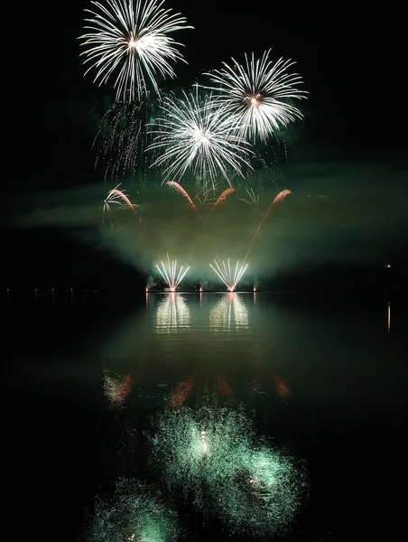 Colorful fireworks with reflection on lake. — Stock Photo, Image