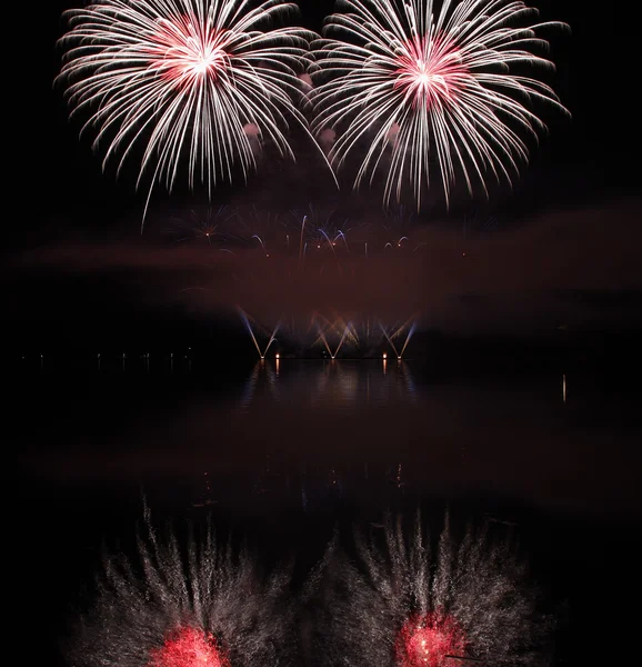 Farbenfrohes Feuerwerk mit Spiegelung am See. — Stockfoto