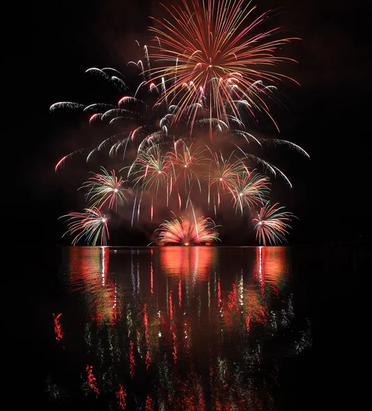 Colorful fireworks with reflection on lake. — Stock Photo, Image