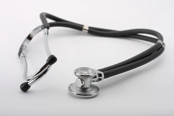 Black stethoscope on white background, close up view. — Stock Photo, Image