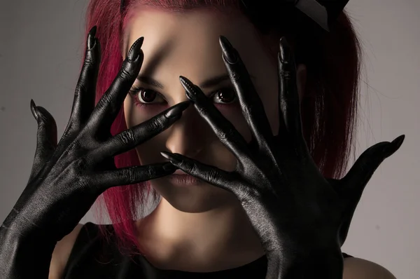 Beautiful woman with red hair and black paint on hands — Stock Photo, Image