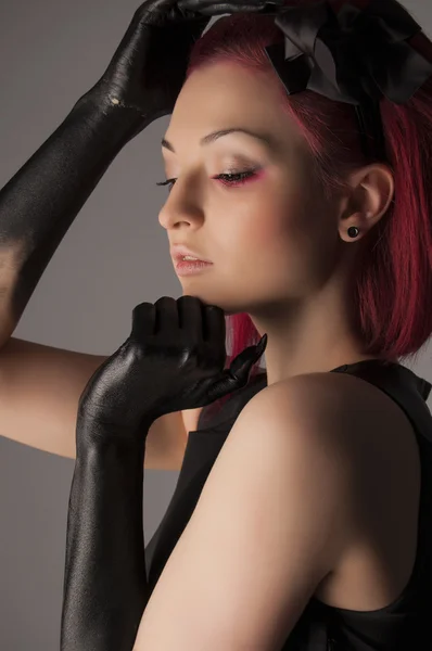 Mulher bonita com cabelo vermelho e tinta preta nas mãos — Fotografia de Stock