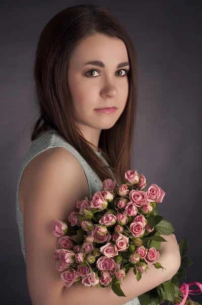 Portrait of beautiful charming brunette woman with punk flowers. Fashion photo — Stock Photo, Image