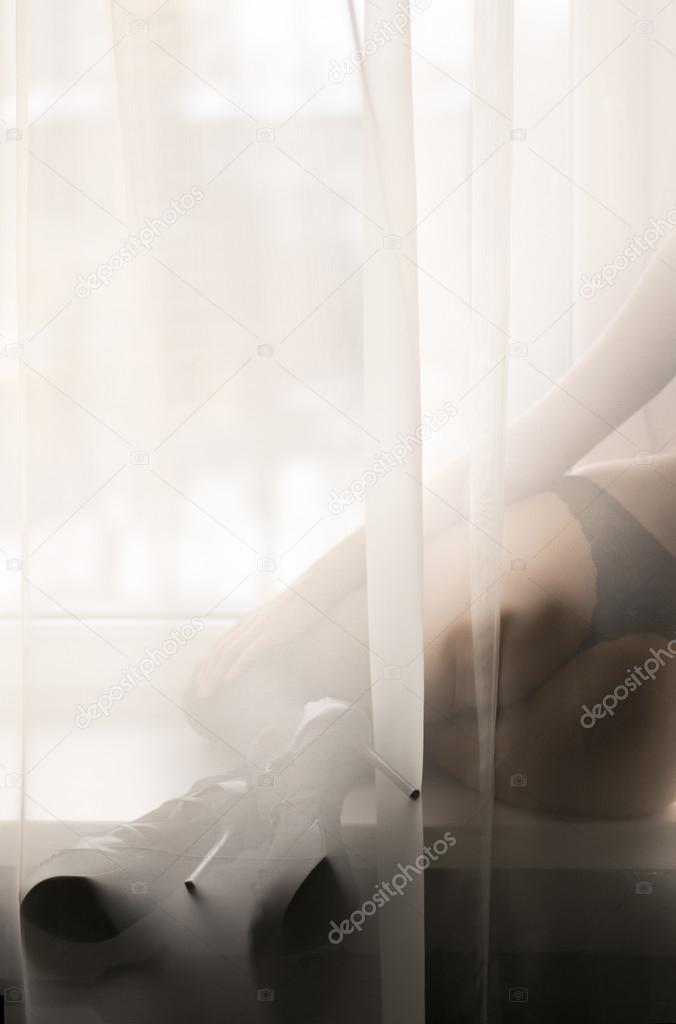 Perfect shaped silhouette of hiding in tulle elegant seductive young lady wearing lingerie or bikini having fun happy relaxing over window light copy space background