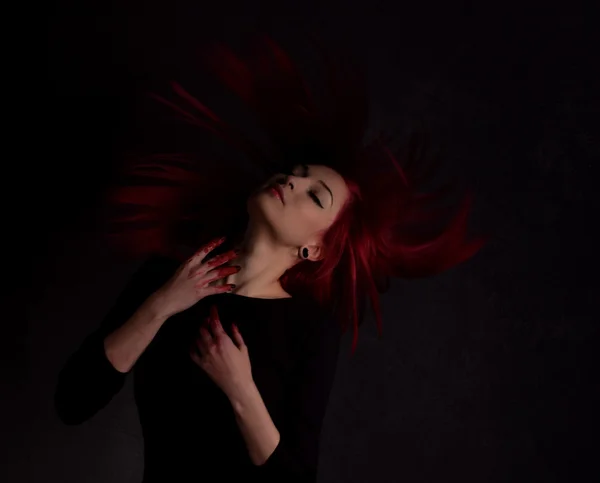 Dark portrait of a beautiful girl with developing long red hair and fingers in blood — Stock Photo, Image