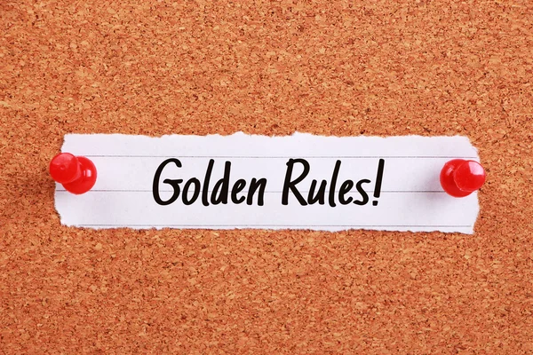 Text Golden Rules written on note paper pinned on the corkboard.