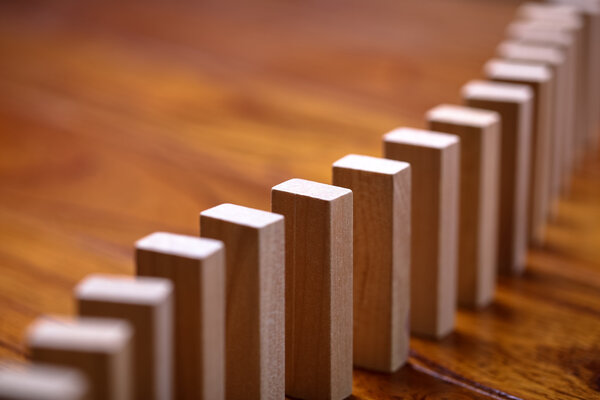 A lot of wooden block standing in a line. Domino Effect Concept