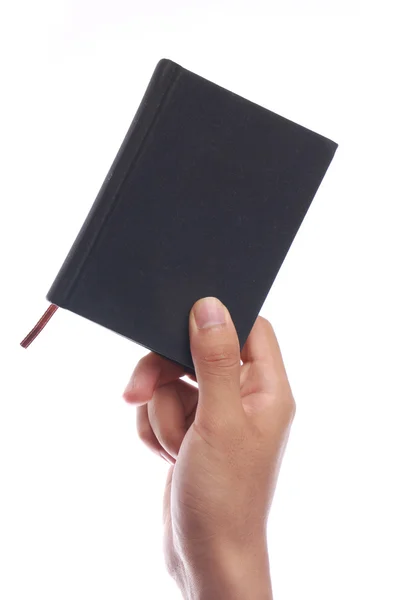 Держать в руках маленькую книгу — стоковое фото
