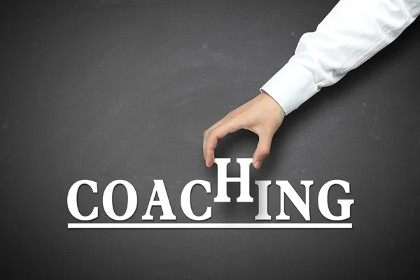 Mão segurando conceito de coaching — Fotografia de Stock