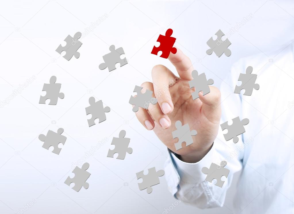 Puzzles with businessman hand