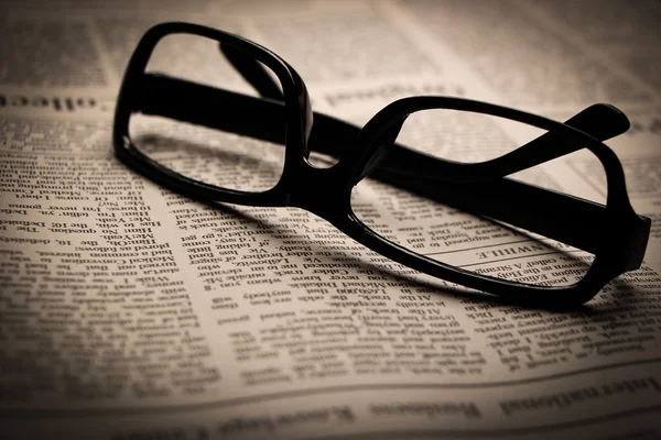 Glasses on newspaper — Stock Photo, Image