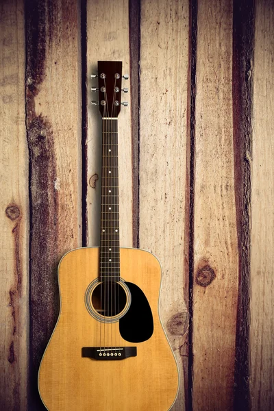 Acoustic guitar on wooden background — Stock Photo, Image