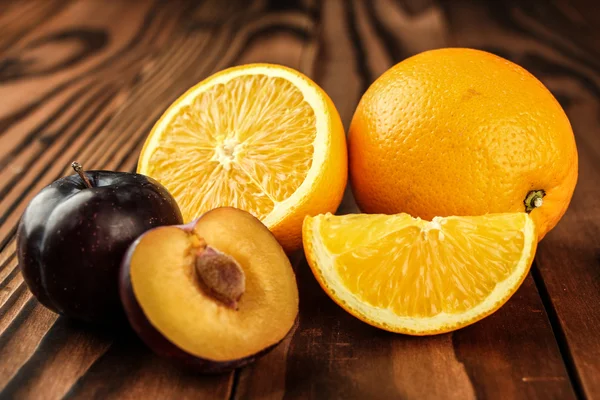 Friss szilva és narancssárga gyümölcs — Stock Fotó