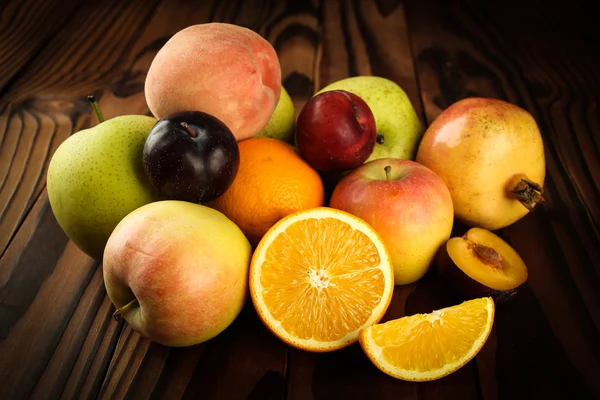 Assortment of exotic fruits on the wooden table — Stock Photo, Image