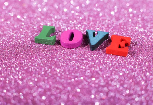 Ordet kärlek med glittrande bakgrund — Stockfoto