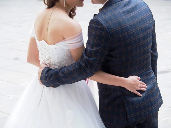 Asian couple are facing each other and embracing