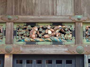 A carving of Three wise monkey in Nikko, Japan. clipart