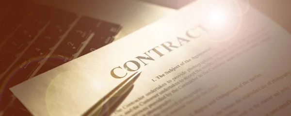 Sözleşmeyi imzaladığın için kalem. Kalem ve sözleşme dizüstü bilgisayarda. İş konsepti.