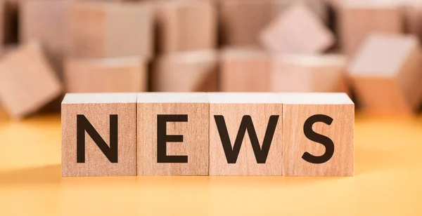 Bulanık küplerle sarı arkaplanda tahta küplerin inşa edilmesiyle ortaya çıkan haberler..