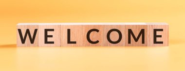 Kelime karşılama sarı arka plandaki tahta bloklara yazıldı.