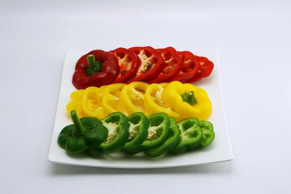 Set of slightly cut sweet pepper on dish 3 — Stock Photo, Image