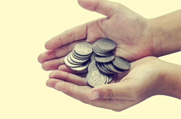 Hands of children and coins Stock Image