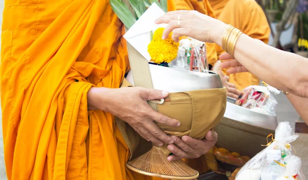 Giving alms to monks receive alms Royalty Free Stock Images