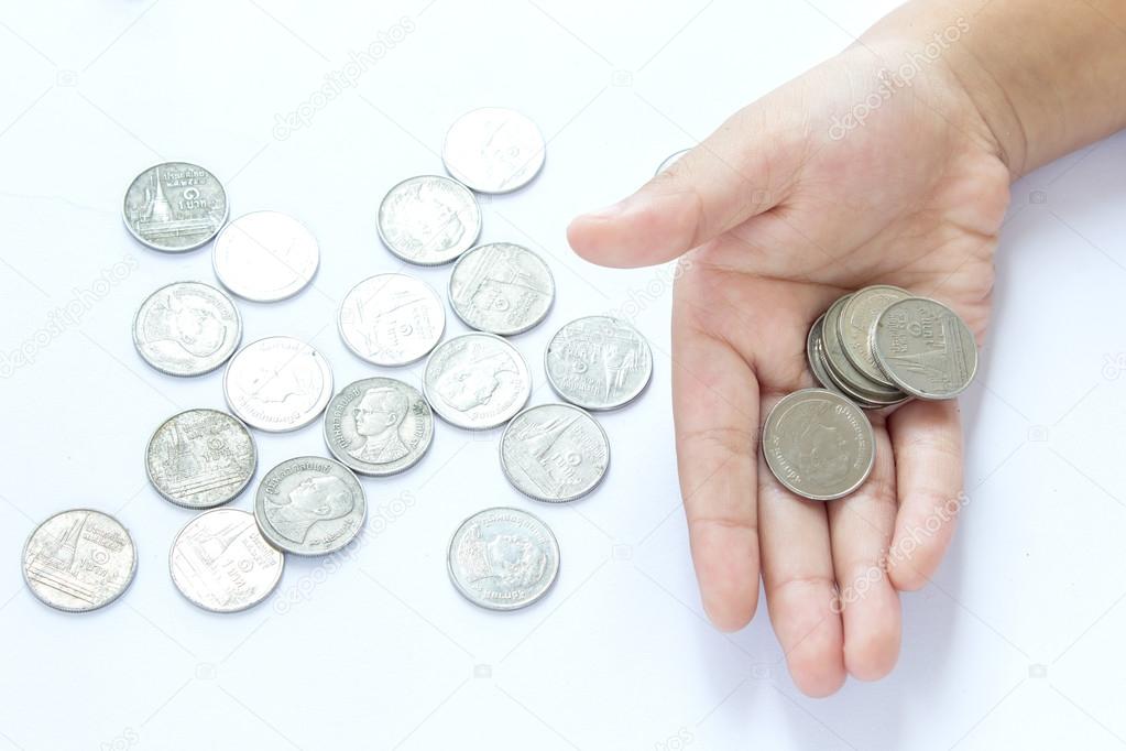 Hands of children and coins