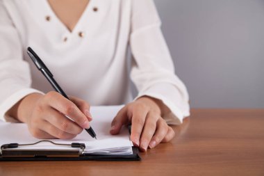 İş kadını belgelere yazıyor. Ofiste..