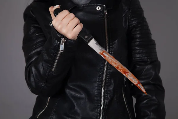 Caucasian killer bloody knife in hand. Crime concept.