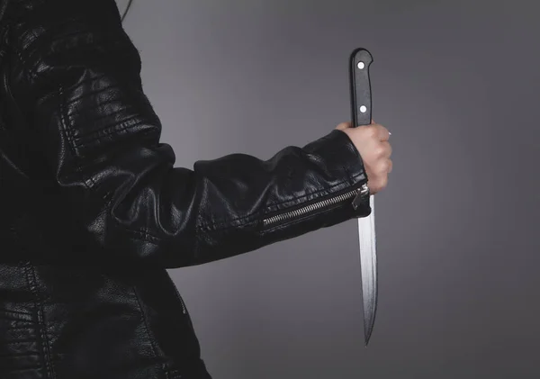 Caucasian killer knife in hand. Crime concept.