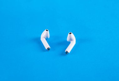 Mavi arka planda kablosuz kulaklık..