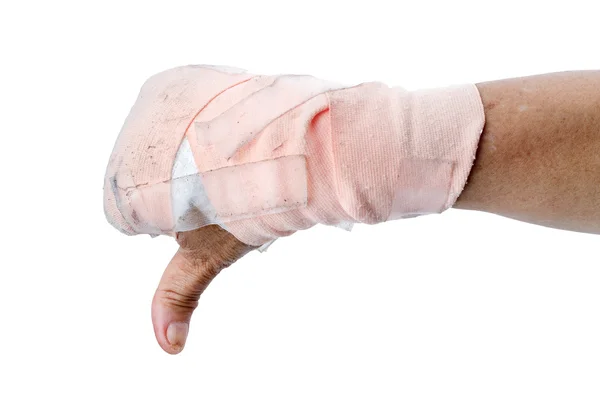 Tummen ner visar för hand med bandage isolerad på vit — Stockfoto