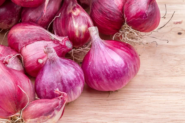 Shallots or red onion, purple shallots on wooden background , fresh shallot  for medicinal products or herbs and spices Thai food made from this raw  shallot 10238227 Stock Photo at Vecteezy