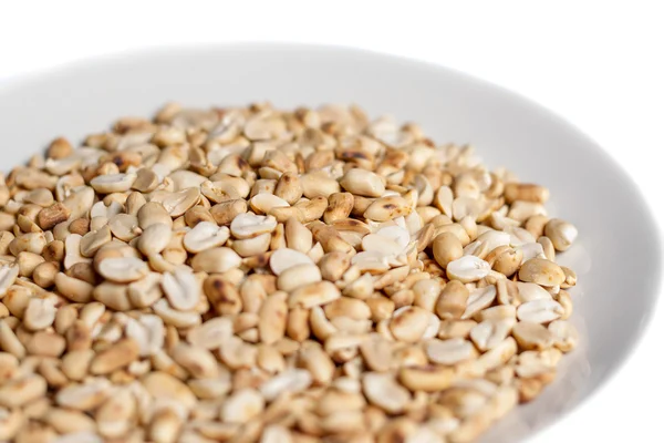 Roasted peanuts in a plate on white background — Stock Photo, Image