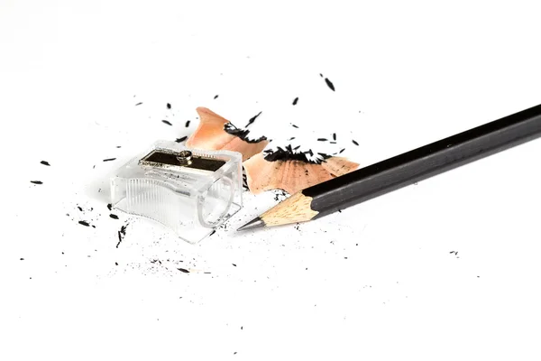 Pencil with sharpening shavings on white background — Stock Photo, Image