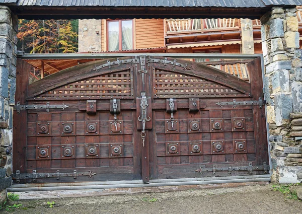 Large wooden country house gate with bolt. Architecture