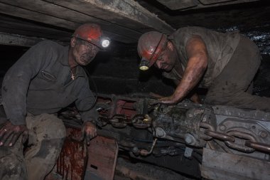 Donetsk, Ukraine - August, 16, 2013: Miners near the coal mining clipart