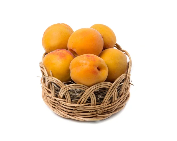 Apricots in a wicker basket. Isolated on white background — Stock Photo, Image