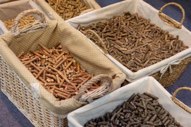 Wicker baskets with different kinds of pelleted compound feed on agricultural exhibition. Industry