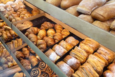 Assortments of different bakery products on the bakery showcase. Food